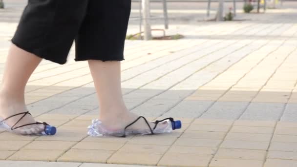 Womans feet defile in plastic bottle shoes — Stock Video