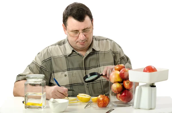 Phytocontrol expert stares at the halved apple — Stock Photo, Image