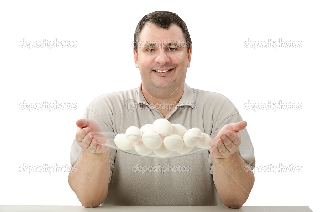 Smiling farmer holding a glass basket of eggs