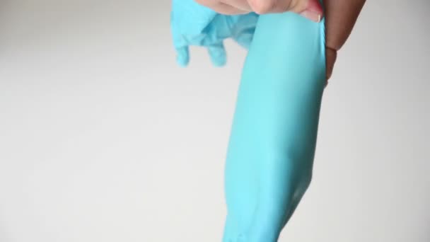 Putting blue latex gloves on hands — Stock Video