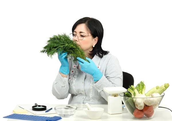 Phytocontrol technician smelling dill — Stock Photo, Image