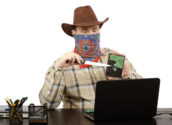 Cowboy holding a knife and hard disk threats on Skype — Stock Photo, Image