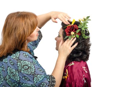 Red-haired hairstylist putting in a red rose in her hair custome clipart