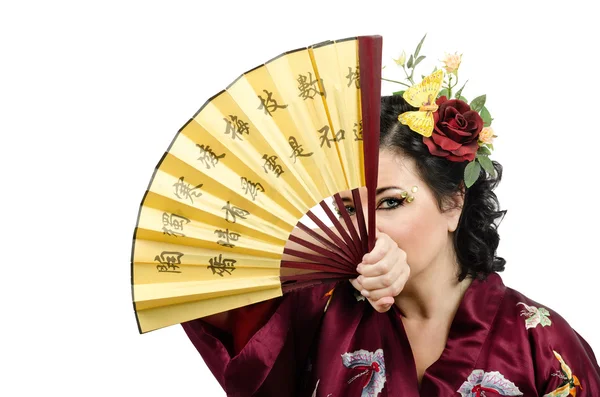 Kimono kvinnan tittar på dig genom den öppna fan — Stockfoto