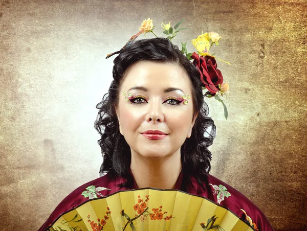 Face portrait of a stylized kimono woman with fan — Stock Photo, Image