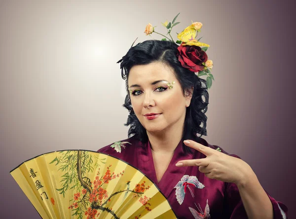 Flowers haired kimono woman doing cool hand gesture — Stock Photo, Image