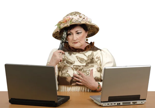 Lost in time old woman reading the news on the laptop — Stock Photo, Image