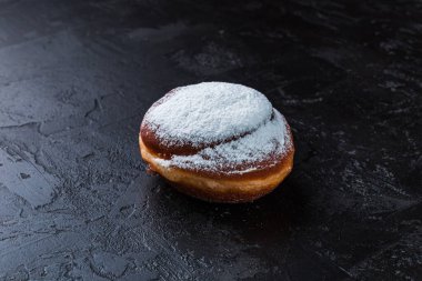 Karanlık bir masada taze pişmiş lezzetli çörek. Pastaneden gelen lezzetli pişmiş yiyecekler. Siyah arkaplan.