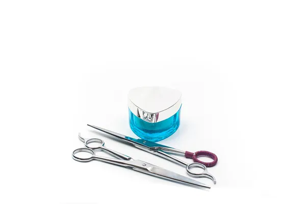 Pair of hair scissors whith beauty cream on white — Stock Photo, Image