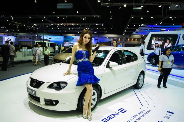 Unidentified modellings posted over The new Proton gen 2 display on stage — Stock Photo, Image