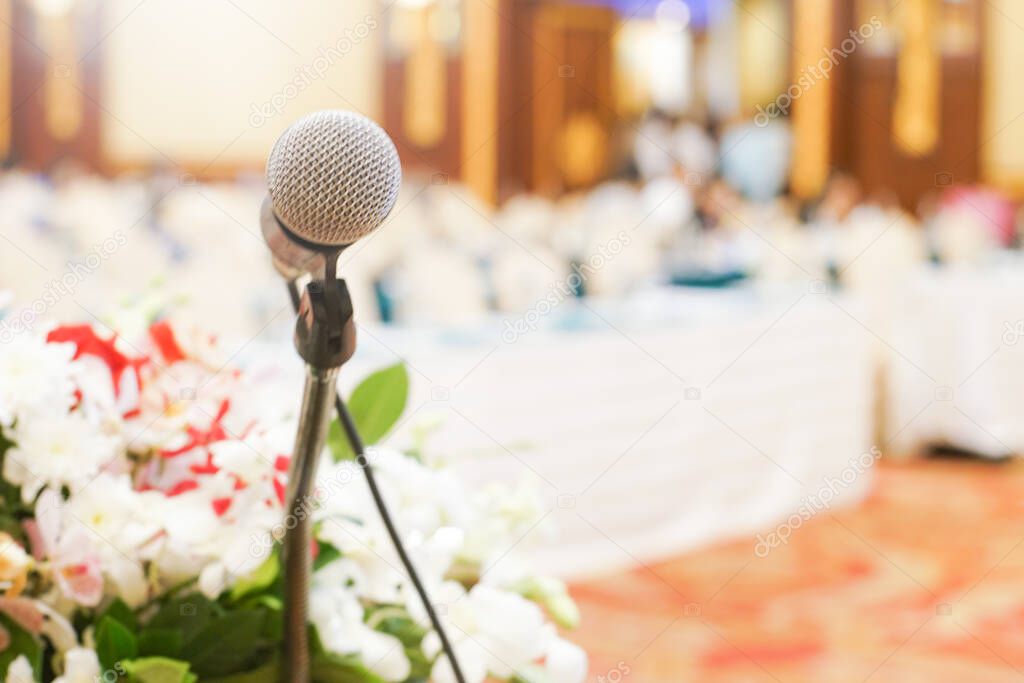 Microphone over the abstract blurred conference hall room business seminar