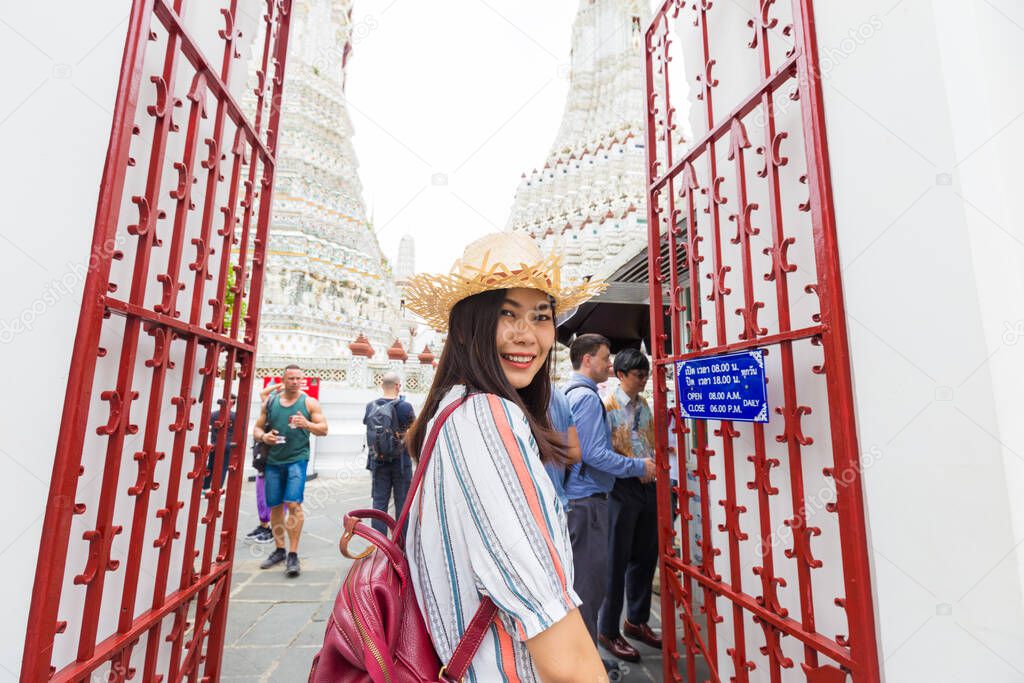 Women wear summer hat walking to travel in temple of dawn Wat Arun Bangkok Thailand