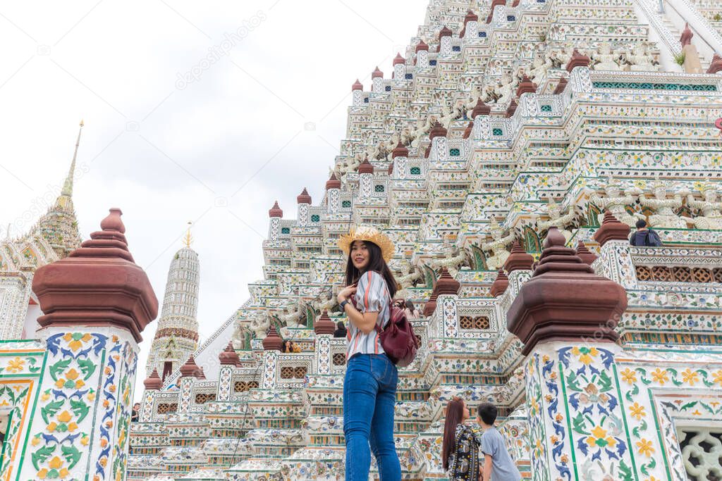 Women wear summer hat walking to travel in temple of dawn Wat Arun Bangkok Thailand