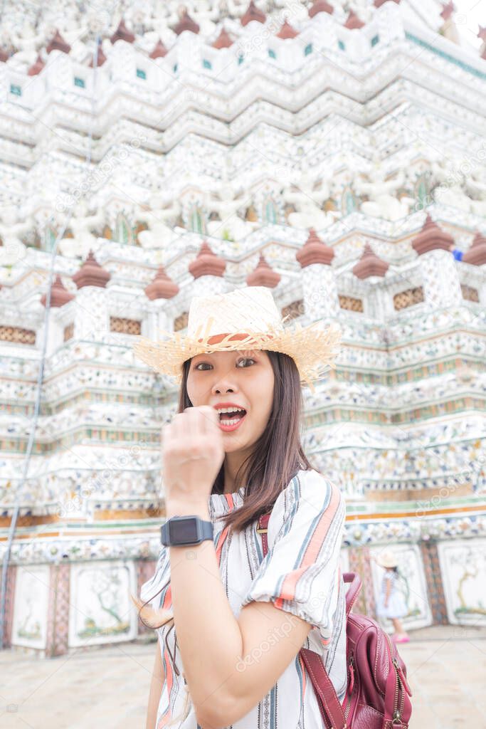 Women wear summer hat walking to travel in temple of dawn Wat Arun Bangkok Thailand