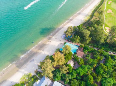 Deniz sahili beyaz kumsalı, dalgalı turkuaz deniz suyu, hava manzaralı.