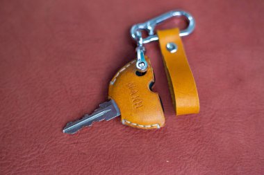 Genuine keychain leather crafts working on red leather background handmade