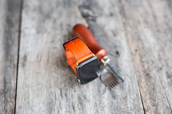 Orange leather smart watch strap hand made on wood craftmanship working