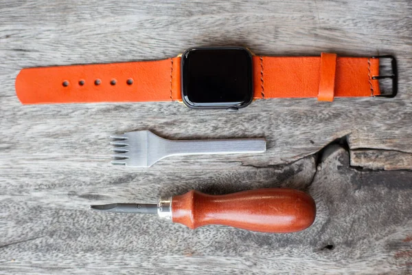 Orange leather smart watch strap hand made on wood craftmanship working