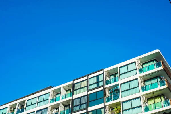 Modern low rise condominium residence against blue sky asset industry