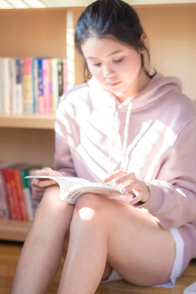Happy Asian Young Woman Reading Book While Quarantin — Stock Fotó