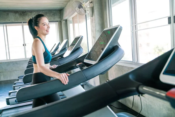 Attractive asian women running on treadmill sport gym healthy life style