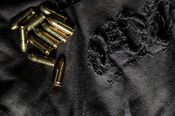 9mm para full metal jacket bullet on vintage cloth self defence concept