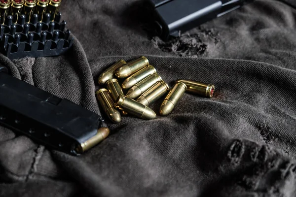 9mm para full metal jacket bullet on vintage cloth self defence concept