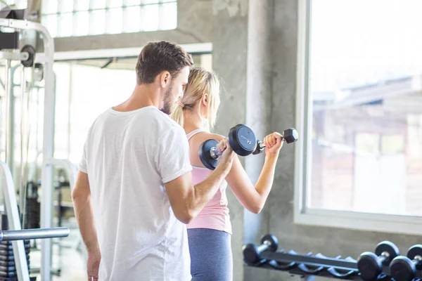 Sporty couple make weight lifting together in loft gym healthy lifestyle