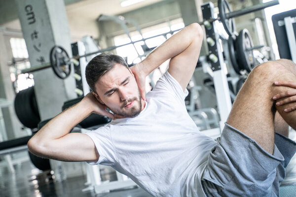 Men and women trainning together sit up make Rectus Abdominis muscular in sport gym