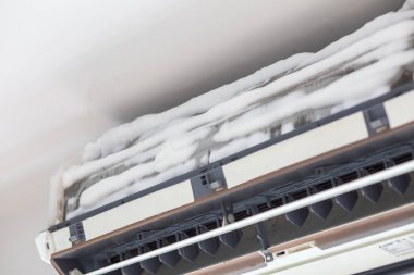 Air conditioning cleanning with foam in white room close up