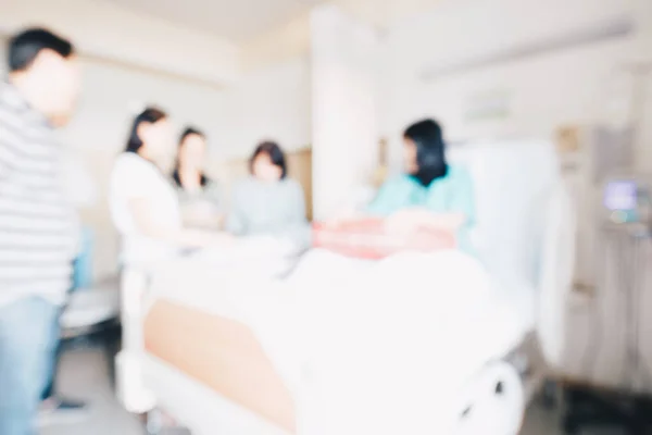 Blurred group of people visit patient in hospital healthy concept