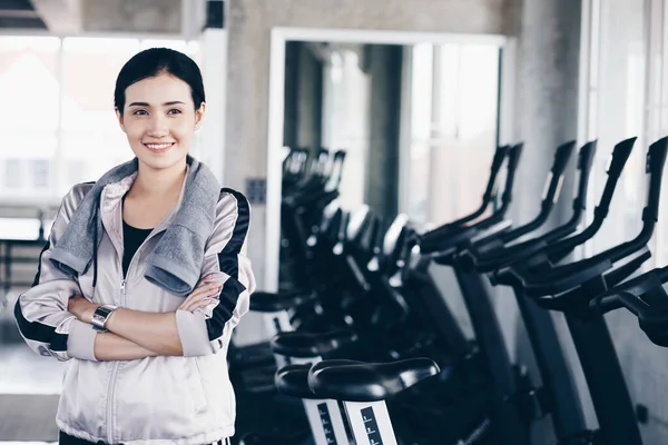 Smiling sport women standing portrait in private gym after working out