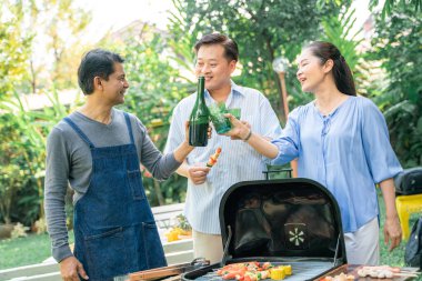 Senior group evening  party in house garden with food and drink life recreation concept