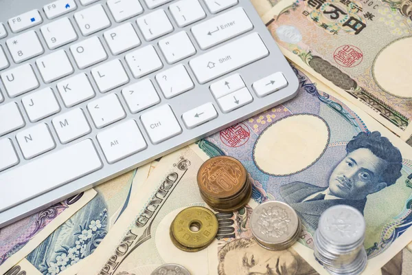 Japanese note bill with computer keyboard, Business technology concept