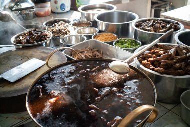 Chef hand cooking hot boiled soup noodle with duck meat in local traditional restaurant, Thailand street food