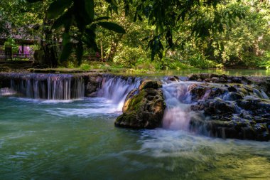 Waterfall in deep tropical rain forest green tree nature scenery
