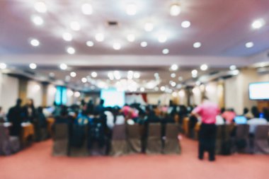 Blurred background group of people in seminar conference hotel room with monitor