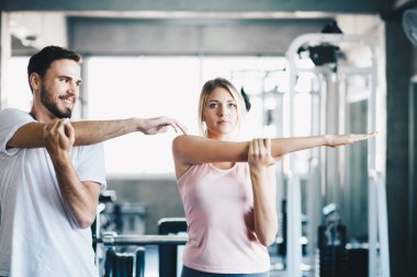 Sport men and women doing stretch before exercise in fitness gym healthy lifestyle