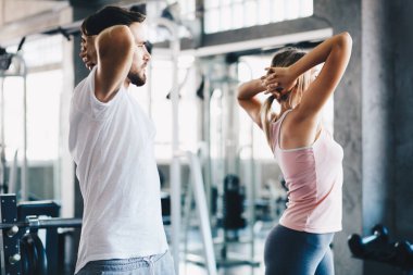Sport men and women doing stretch before exercise in fitness gym healthy lifestyle