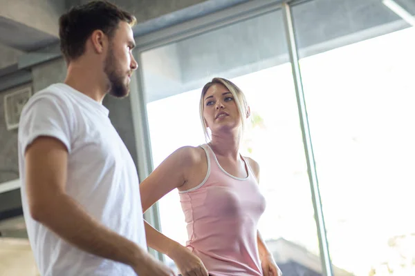 Sport men and women doing stretch before exercise in fitness gym healthy lifestyle