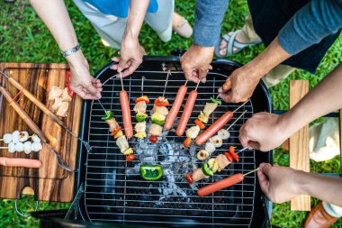 People hand grill BBQ in food party home garden happy friendship