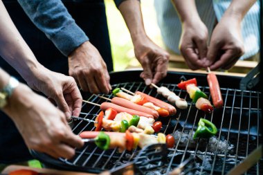 People hand grill BBQ in food party home garden happy friendship