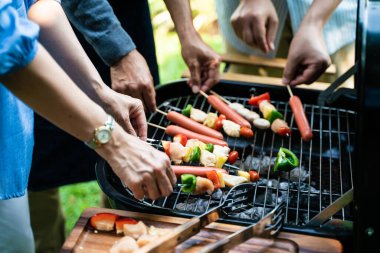 People hand grill BBQ in food party home garden happy friendship