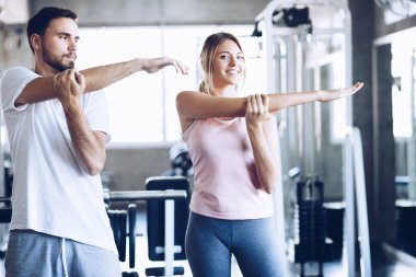 Sport men and women doing stretch before exercise in fitness gym healthy lifestyle