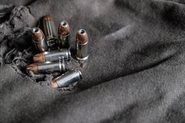 9mm conceal semi automatic gun with jacket hallow point bullet on cloth background