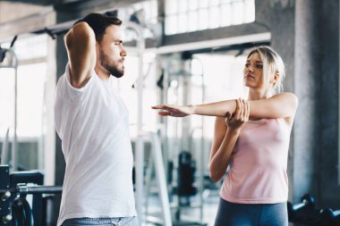 Sport men and women doing stretch before exercise in fitness gym healthy lifestyle