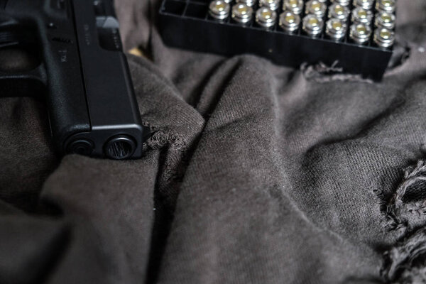 9mm conceal semi automatic gun with jacket hallow point bullet on cloth background