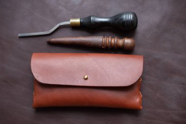 Leather glasses case hand made with craftmanship tool on leather background