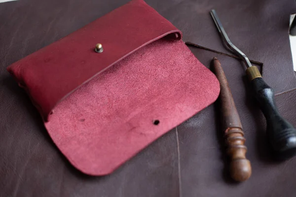 Leather glasses case hand made with craftmanship tool on leather background