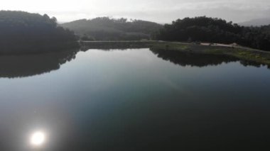Morning sunrise on river dam with mountain aerial movement view nature scene
